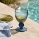 Verre Agine Indigo Blue au bord d’une piscine ensoleillée