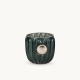 Photophore Dante Lene Bjerre en verre vert sapin avec médaillon de couleur argentée sur fond ivoire clair.